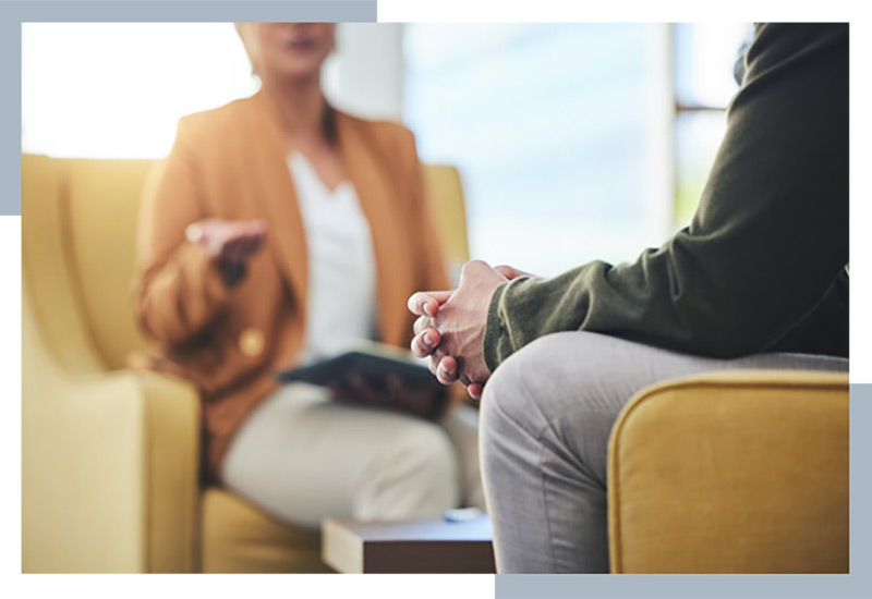 woman sitting down with a person for support